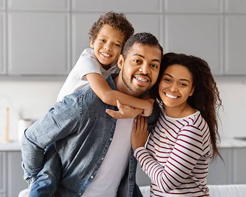 Happy African American Family Standing in Kitchen After Home Purchase in Boston